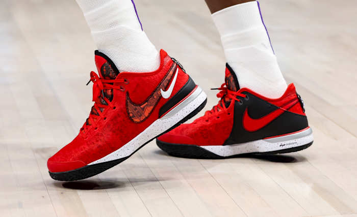 View of LeBron James' red and black Nike shoes.